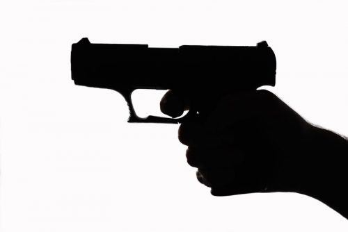 image of figure holding a gun