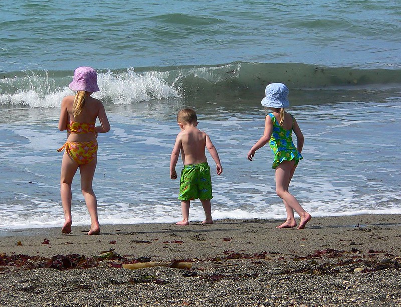 image of three children at the beach