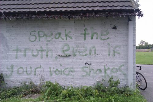 image of 'speak the truth, even if your voice shakes' text written on a wall