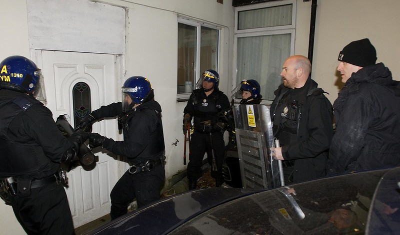image of police raiding a house