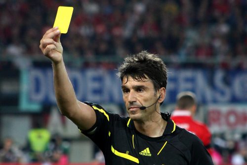 image of referee giving a yellow card