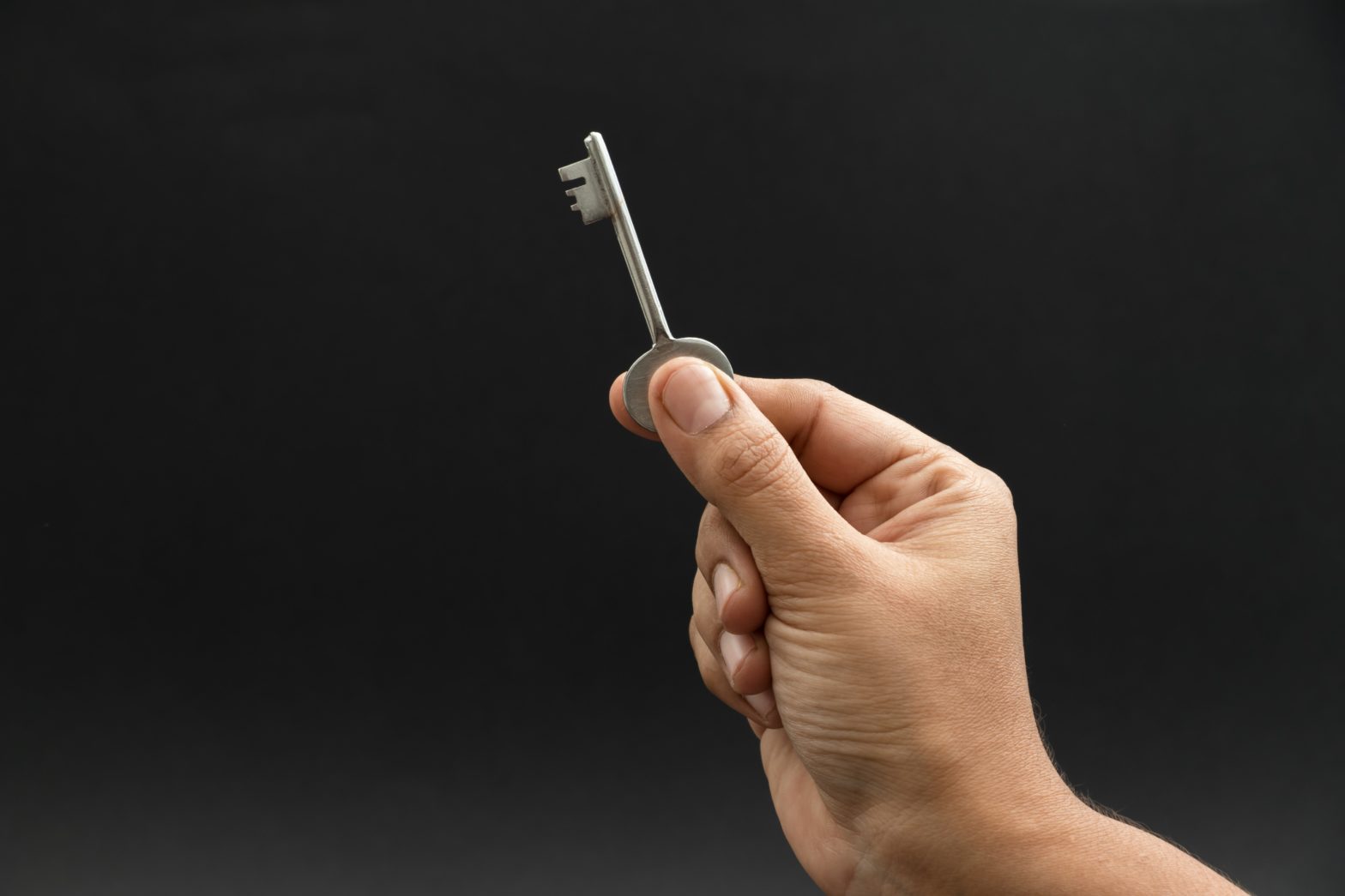 image of person holding a key