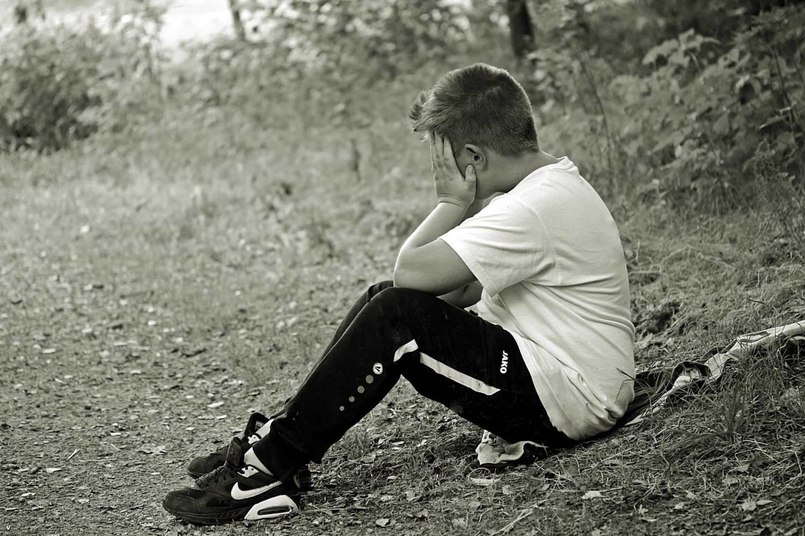 image of boy with head in his hands