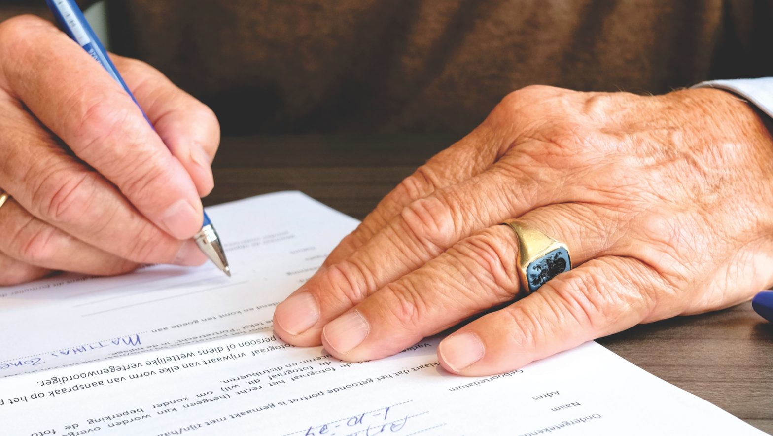 image of man signing a paper