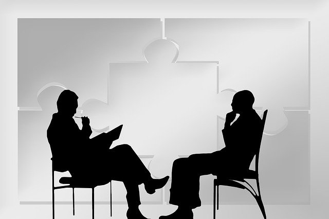 silhouette of two men talking