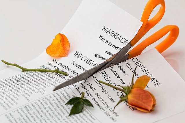 image of marriage certificate being cut up