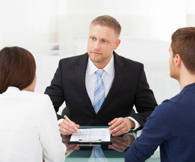 image of couple sitting with a lawyer