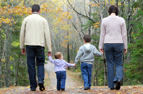 family walking through the woods