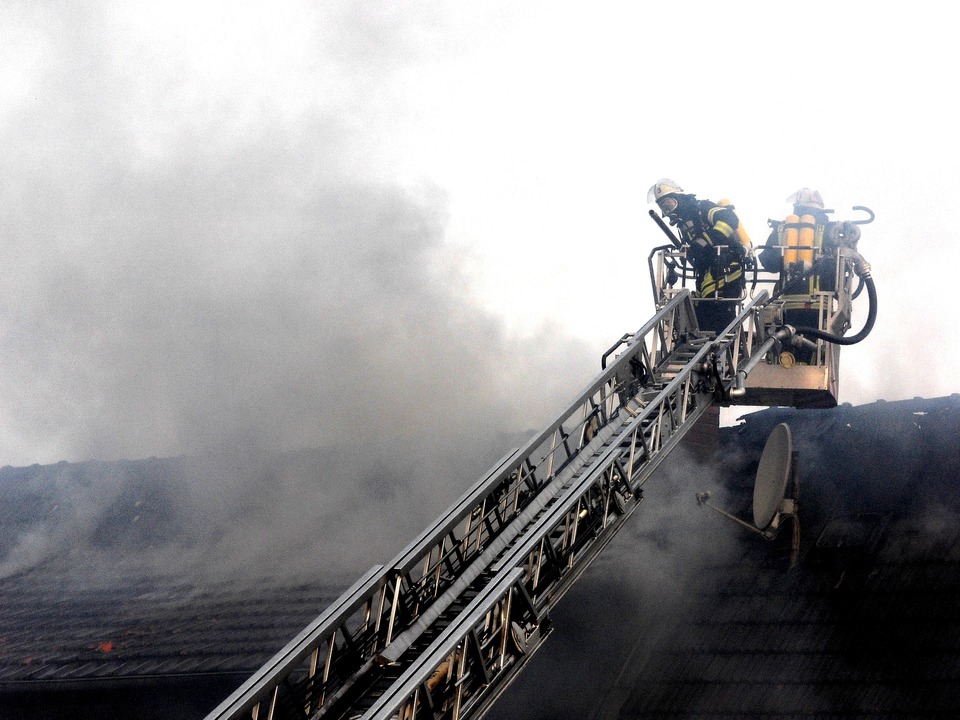 image of fire fighters trying to put out burning house