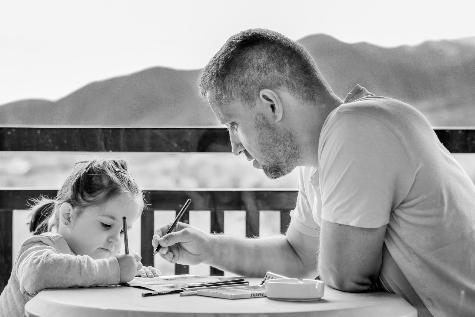 image of man playing daughter with drawing