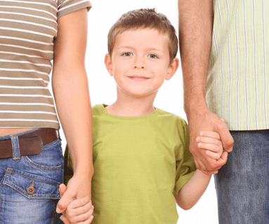 image of young boy holding hands with his parents