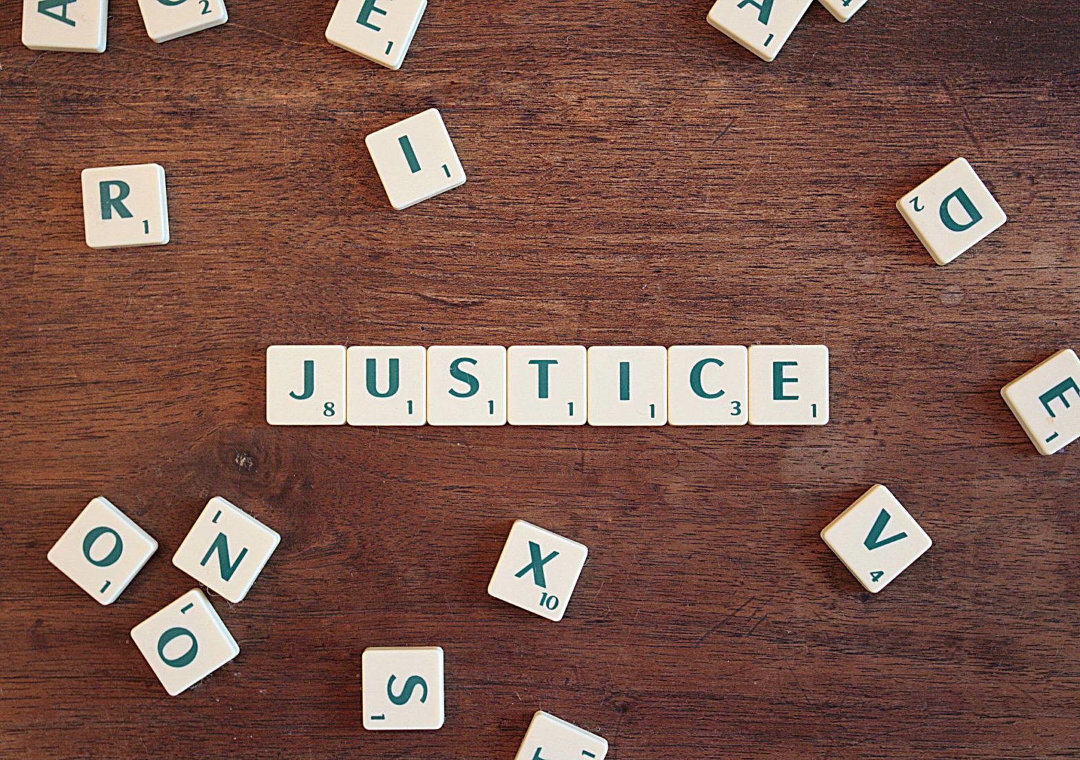 image of justice written in scrabble pieces