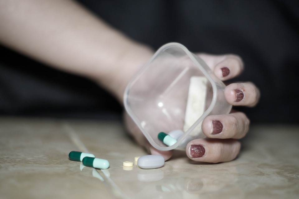 image of a woman taking pills
