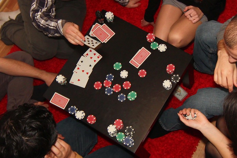 image of table with people playing poker