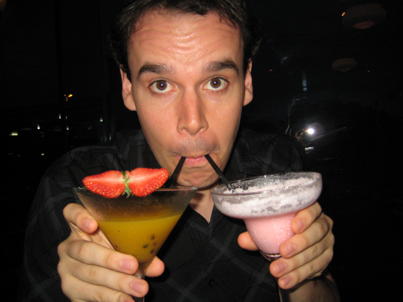 image of a man drinking two cocktails