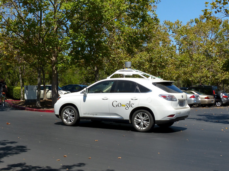 image of a white car with Google printed on the side door