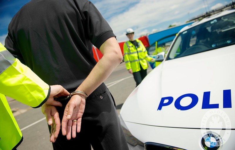 image of a man being arrested by the police