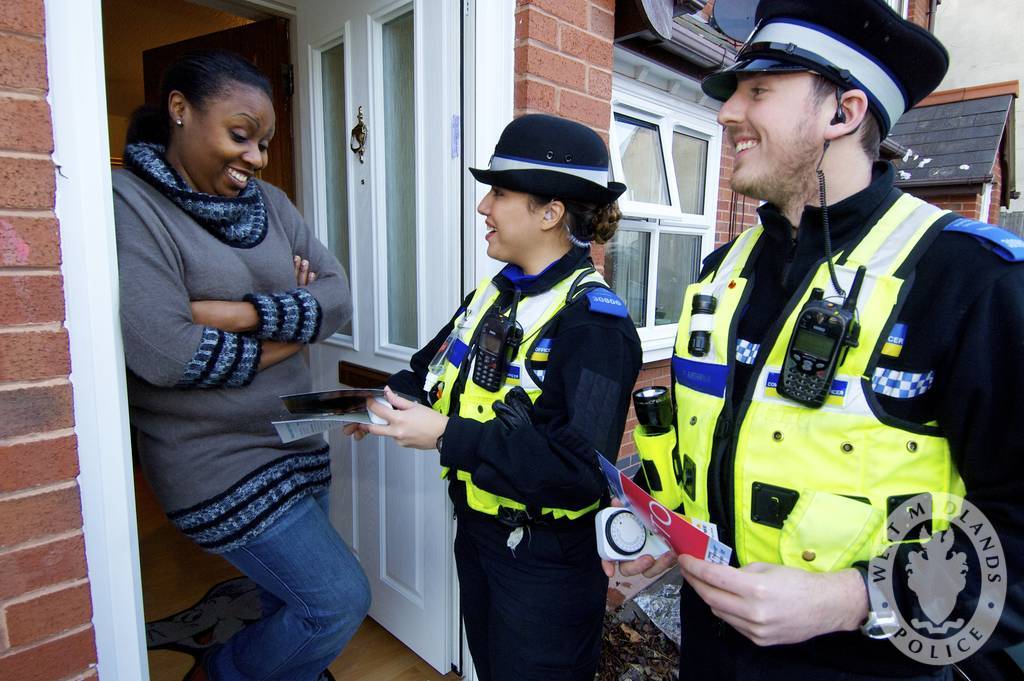 image of two police officers talking to a homeowner