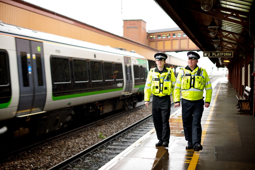 image of two policemen walking on a train platform