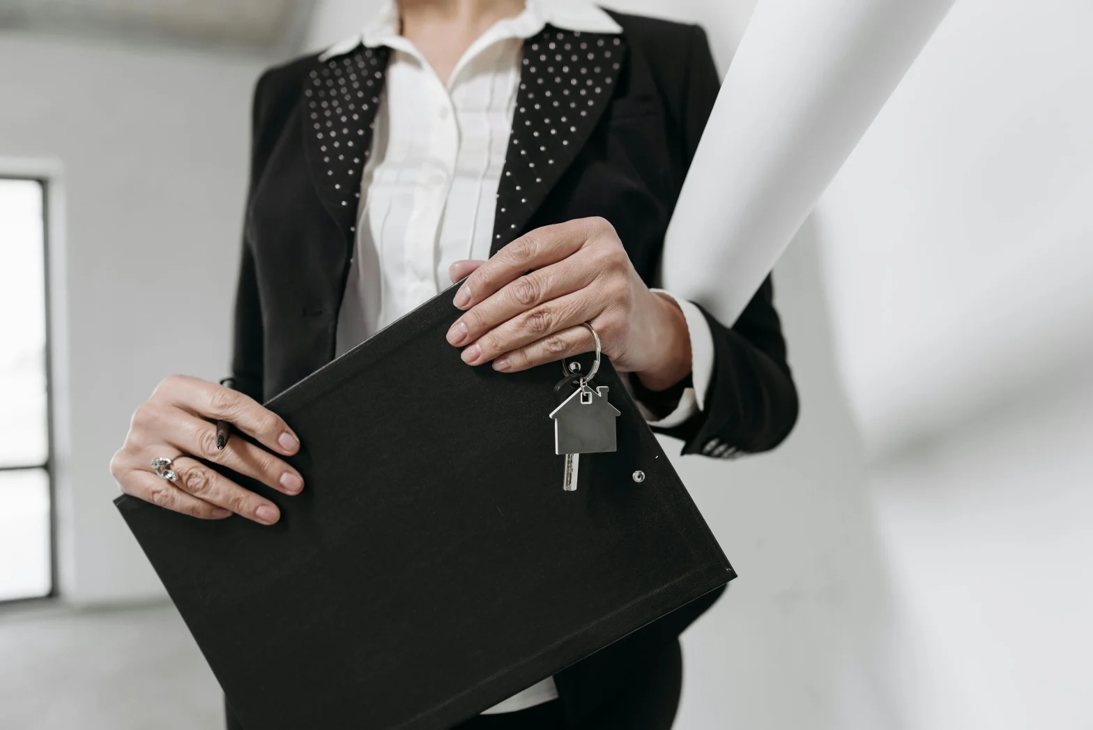 image of a person holding a black clipboard and keys