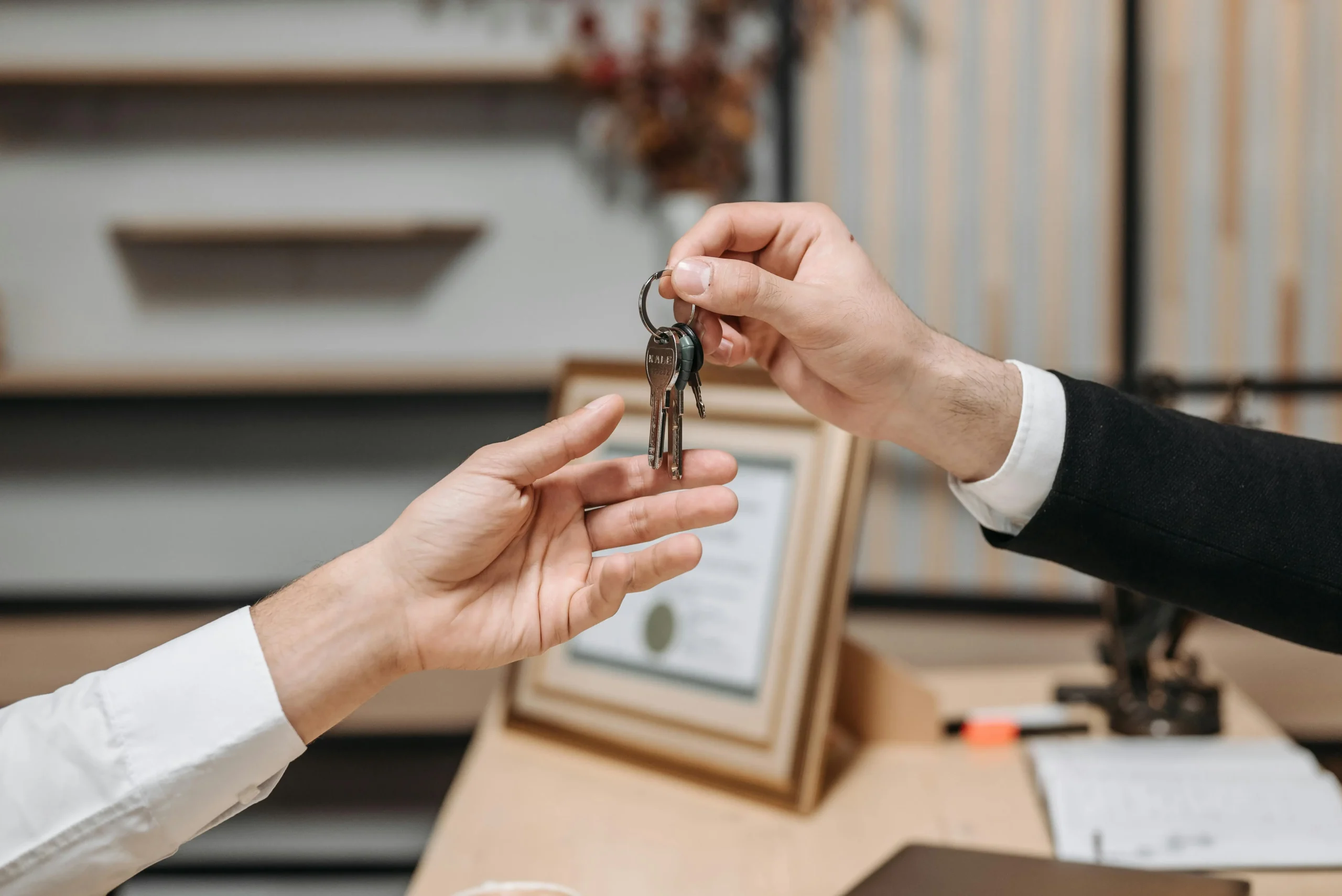 image of a set of keys being handed to another person